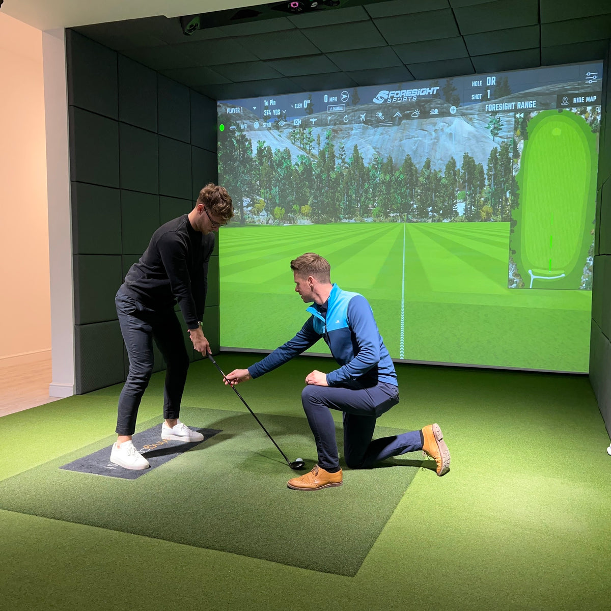 PGA Professional Andy Smith coaching a golfer on the simulator at The Golf Lounge, Birstall